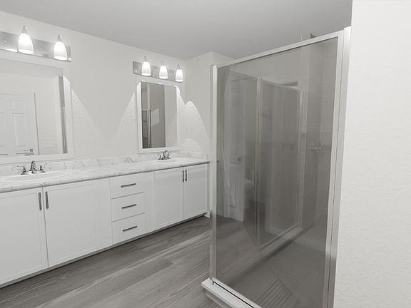 Your suite is complete with a large en-suite bath with dual vanities, a tiled shower, a linen closet