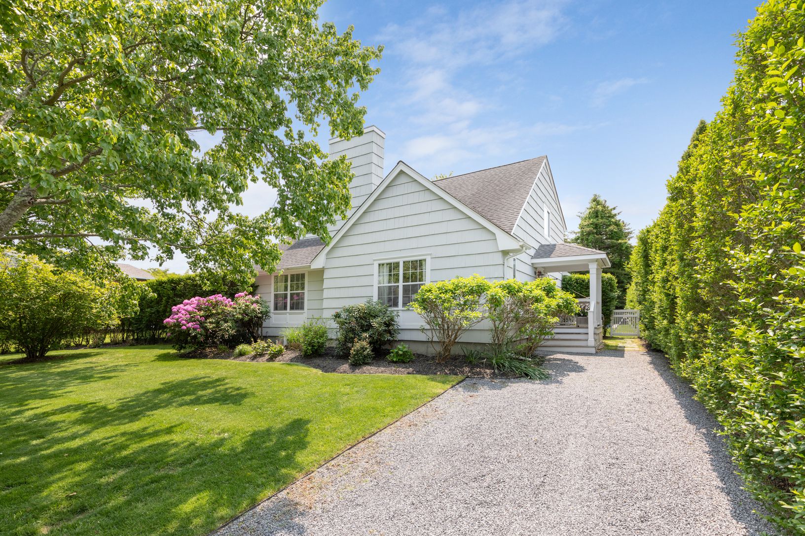  Front of house surrounded by large privet hedges on front and all sides 