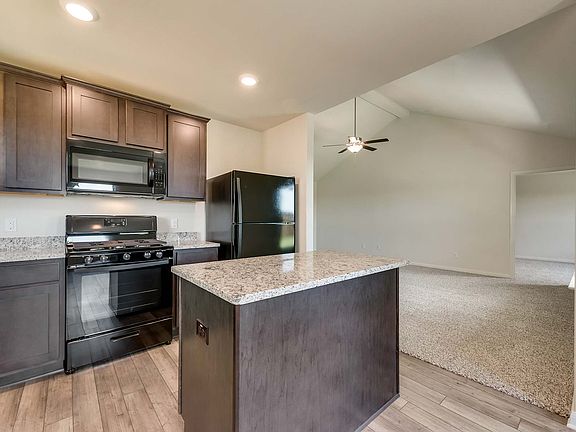 The kitchen has a full suite of energy-efficient appliances and a center kitchen island