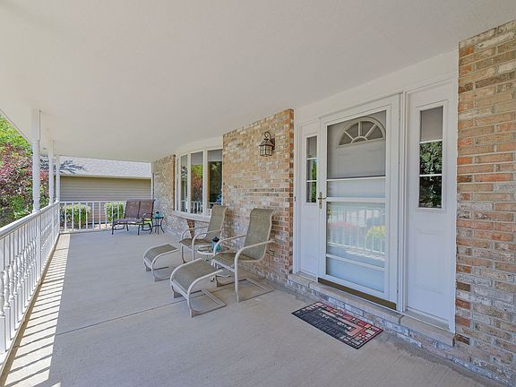 This lovely covered porch is an ideal spot to enjoy the summer nights.