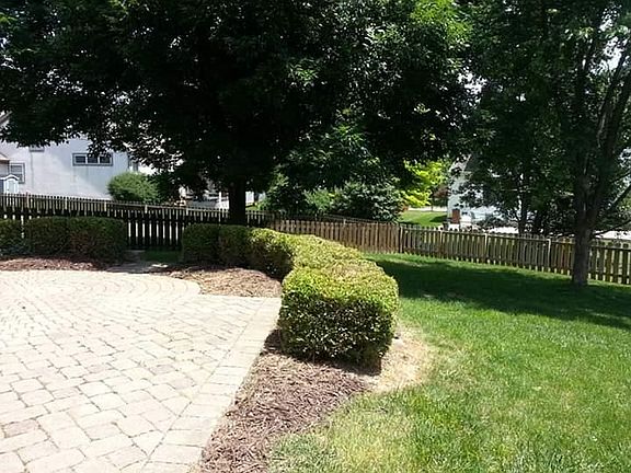 Fenced back yard with brick paver patio