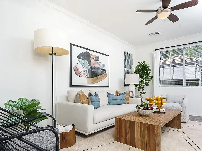 Living Room with Ceiling Fan and Multiple Windows