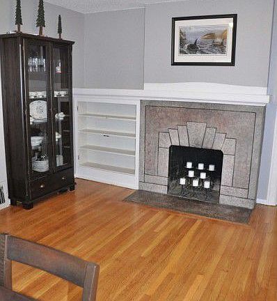 Gorgeous stone fireplace with built in shelves in dining area.