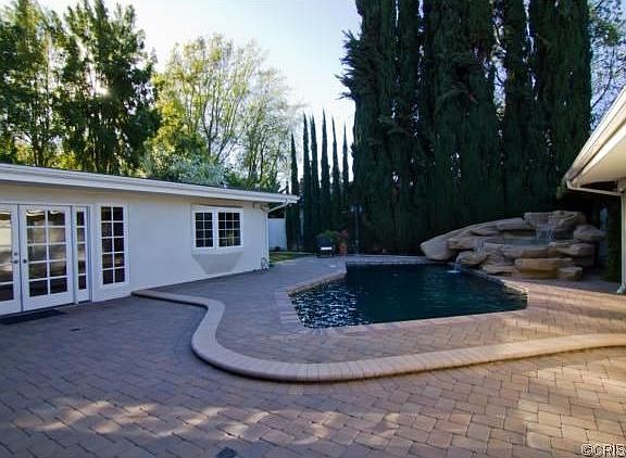 Backyard with pavers and covered patios
