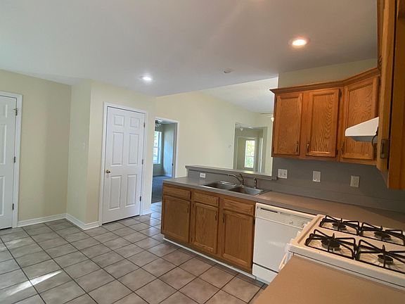 Kitchen has gas stove and dishwasher.