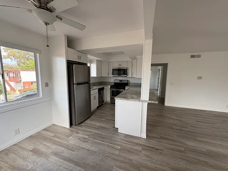 Open concept eat in kitchen and living room.