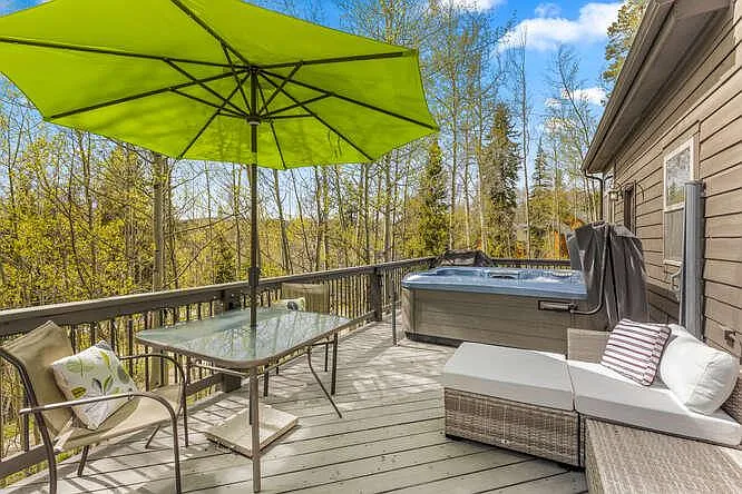 Back deck off of main level, with hot tub and outdoor furniture