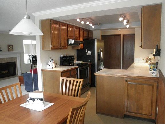 Newer hardwood floors in the entry and hallway. Look at all this storage right off the kitchen!! Is this a great pantry? Plus a coat closet that will accommodate vacuum, brooms, etc.