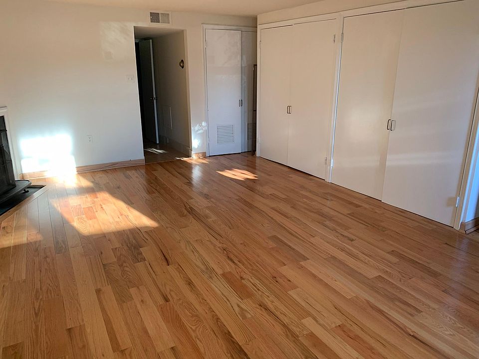 Living room with beautiful hardwood floors plus two large closets