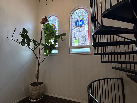 Main living area with original stain glass windows and cathedral ceiling