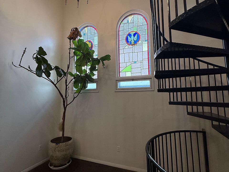 Main living area with original stain glass windows and cathedral ceiling