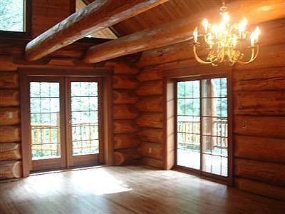 Large dining room with two sets of doors leading to the fabulous deck with south and west exposure. 