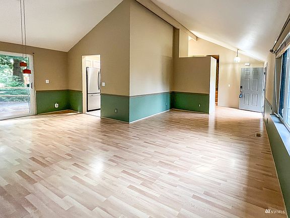 From the living room with entry way on the right, reading nook and formal dining room on the left>