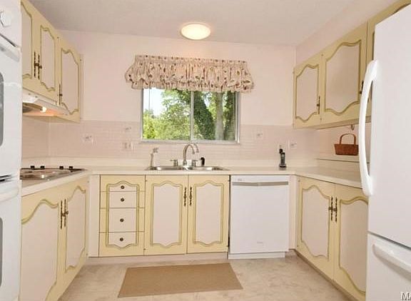 Kitchen  has some newer appliances and flooring.