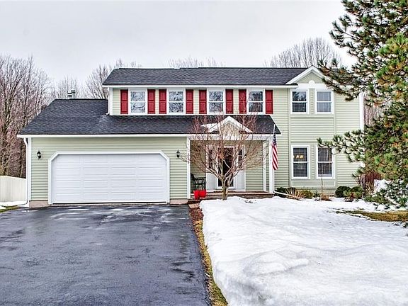 Mature evergreen in front lawn, attractive landscaping just waiting for spring to bloom.
