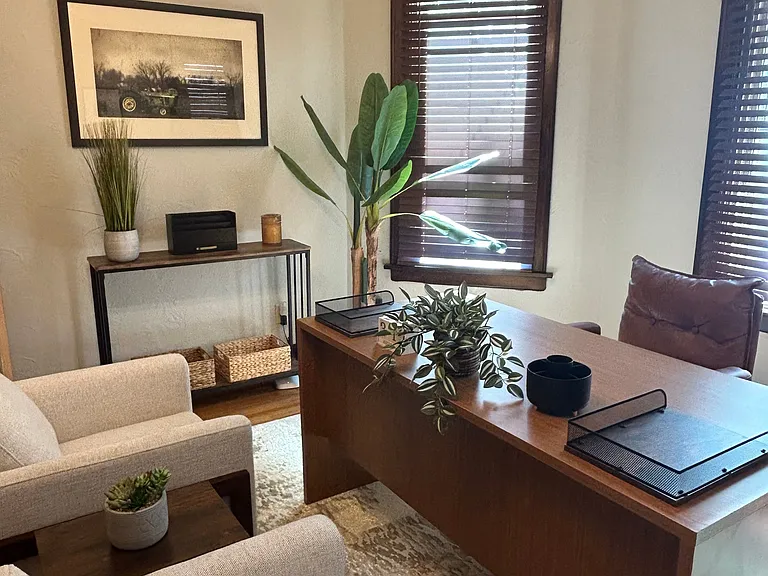 Plenty of natural light with 3 large windows behind your desk. The small table along the wall has plenty of space for your added office decor!