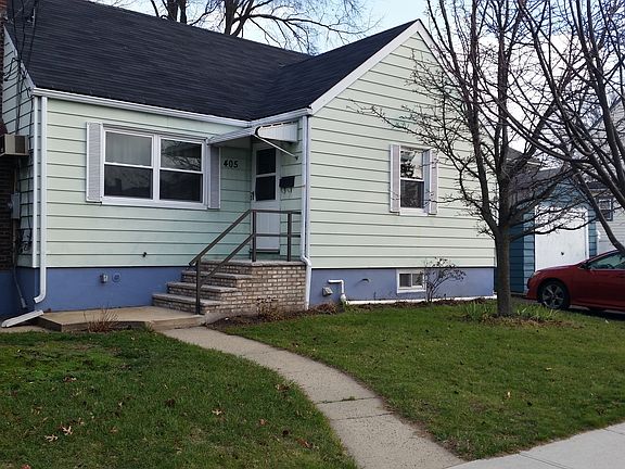 Front view with driveway with parking