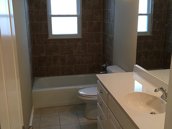 Hall bath with tile tub/shower surround and huge vanity