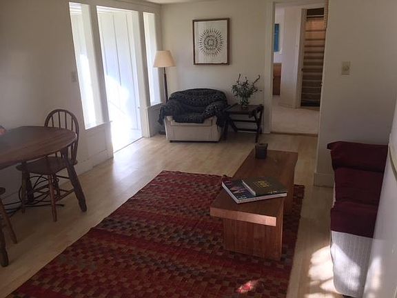 View from kitchen toward seating area, alcove room on the left and bedroom/bath beyond