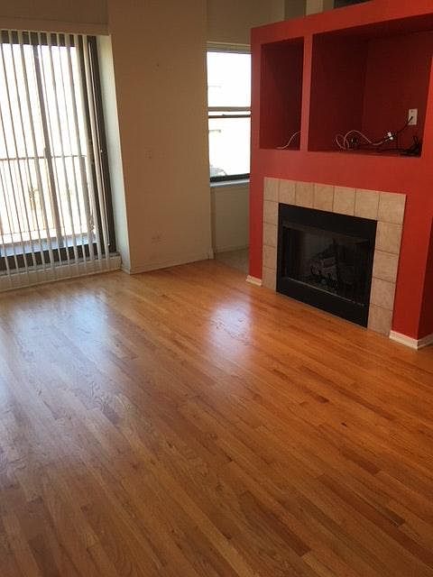 Large living room with gas fireplace and balcony