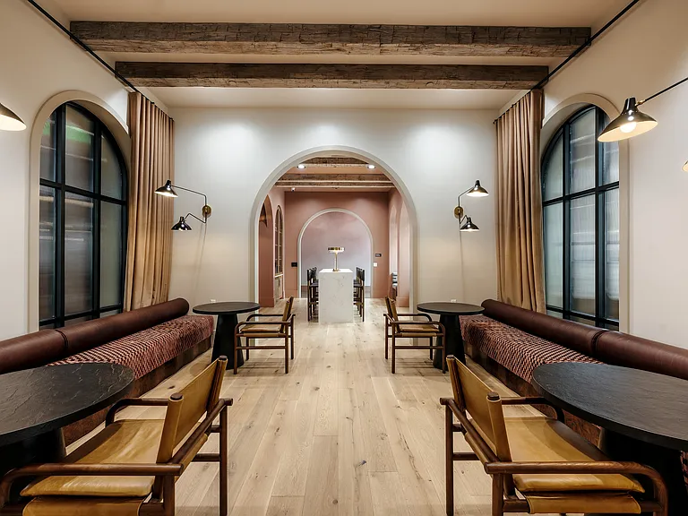 Luxury apartment co-working lounge with WiFi, booth seating, private workspaces, and designer interiors.