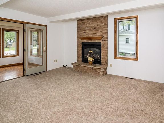 The living room is spacious and has a stone fireplace with gas logs.  Ceiling beams add architectural interest.