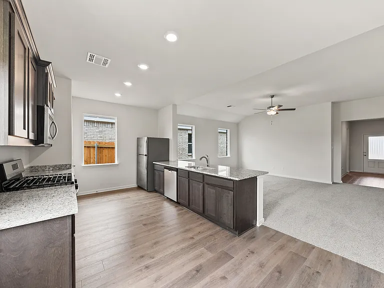 The kitchen has sprawling granite countertops.