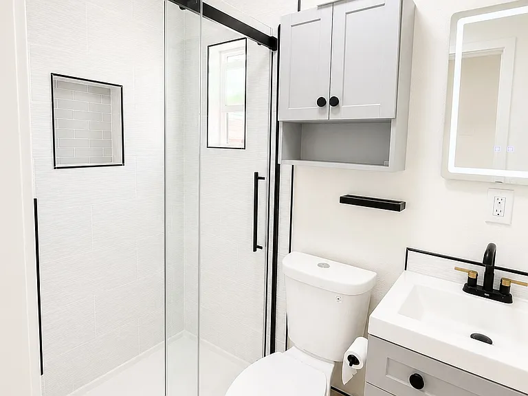 Gorgeous bath with tile shower, glass doors and touch LED Mirror