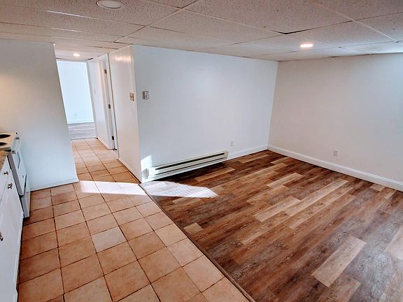 kitchen and living room facing hallway to bedrooms and bathroom