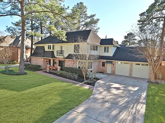 Champion Forest homes are prized for their uniqueness and architectural charm. 9703 Fenchurch Drive is a custom home with paver walkway and front patio for hosting the friendly neighbors. The iron railing provides a sense of privacy, and matches the 