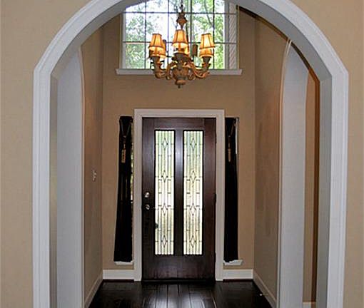Impressive two-story entrance with leaded glass door, upgraded lighting & plenty of architectural de
