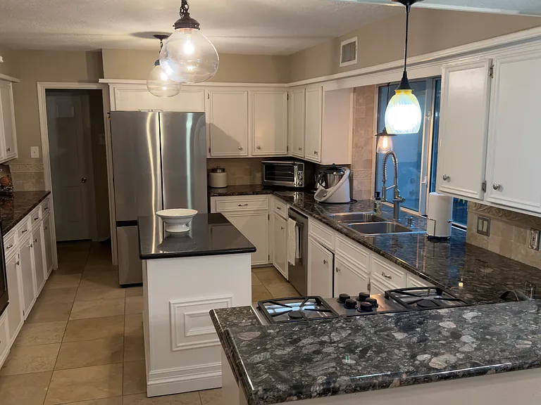 Granite countertops with new stovetop, in-wall stove and new refrigerator