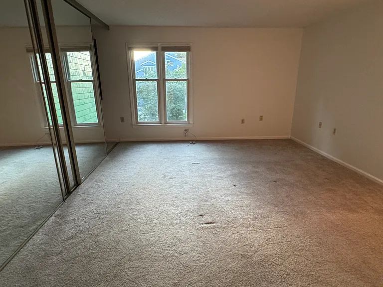 Master Bedroom includes floor to ceiling glass mirror doors with custom California Closet