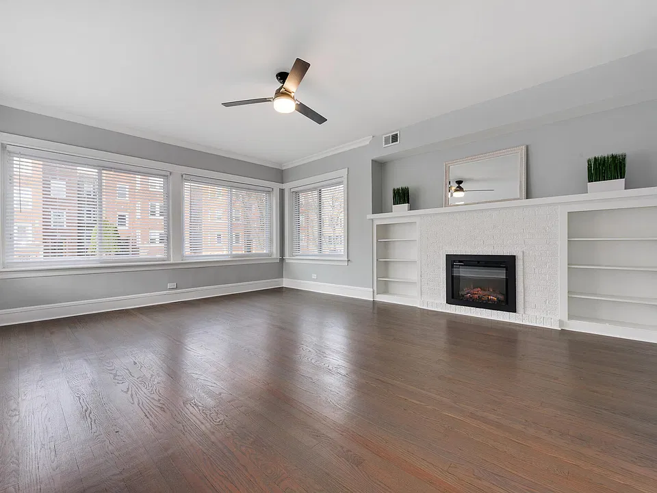 Large living room with fireplace and natural light