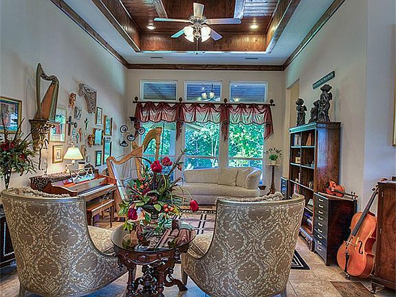 THE FORMAL LIVING ROOM WITH WOOD CEILING AND TRIM