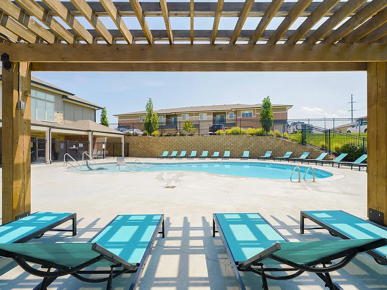 Relax in the shade under our pool-side pergola.
