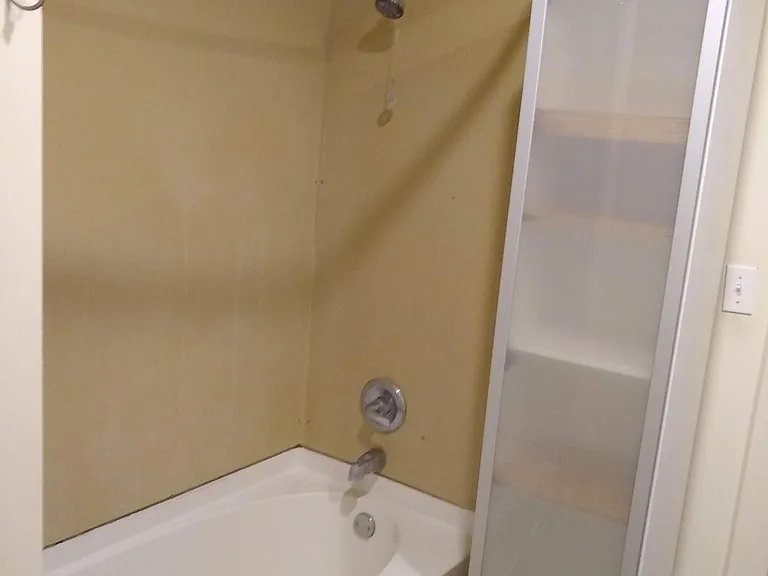 First floor bathroom - tub/shower and storage cabinet
