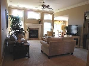 Living Room: crown molding, open design & gas fireplace flanked by windows...