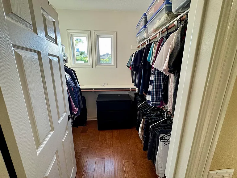 1 of 2 walk-in closets in Primary Bedroom