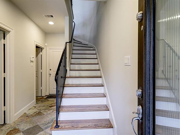 The bottom floor has one bedroom, a utility room and access to the garage.