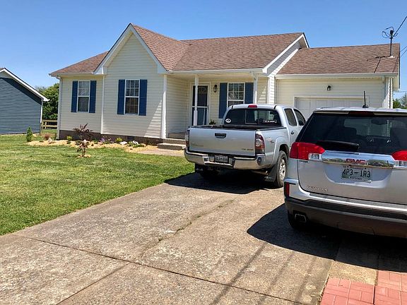 Front yard with expanded parking for two vehicles with pavers