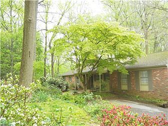 Front of house shows part of parking area