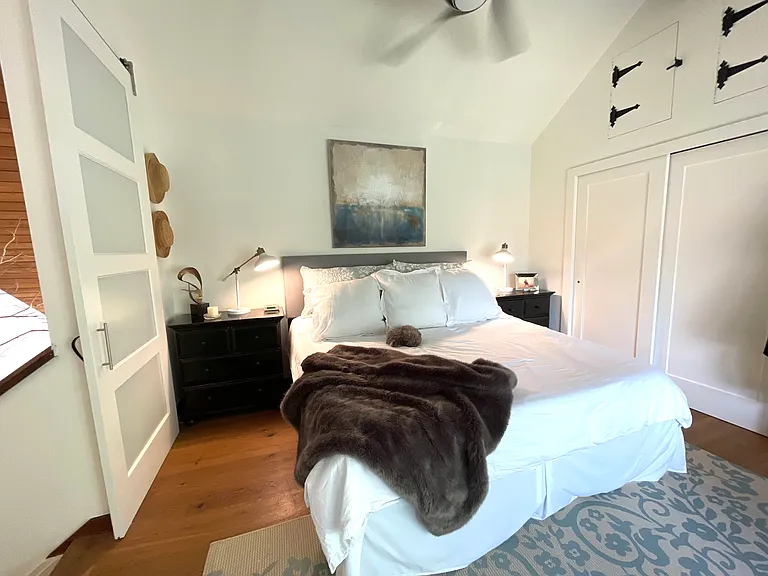 Upstairs Primary Bedroom, attached full Bath, high ceilings, lots of closet space and book case with gorgeous east facing sunrises.