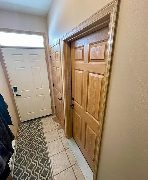 Main Entrance door, coat closet and entry door to attached 2 car garage.