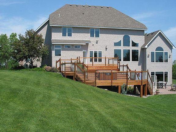 Back of house with 2 tier deck, hot tub and paver walk out patio