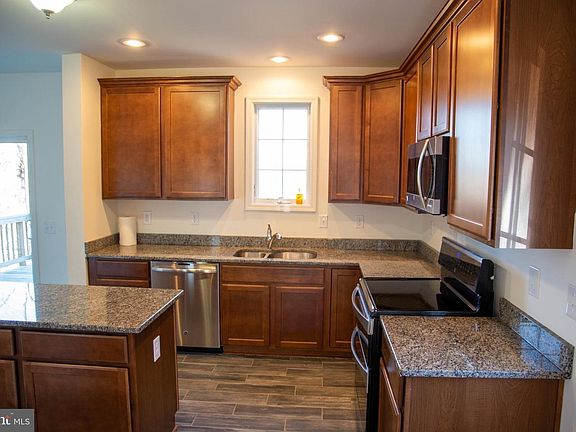 Kitchen (Prior to painting). Dishwasher, electric double oven stove, microwave and large fridge with French doors and drawer freezer.