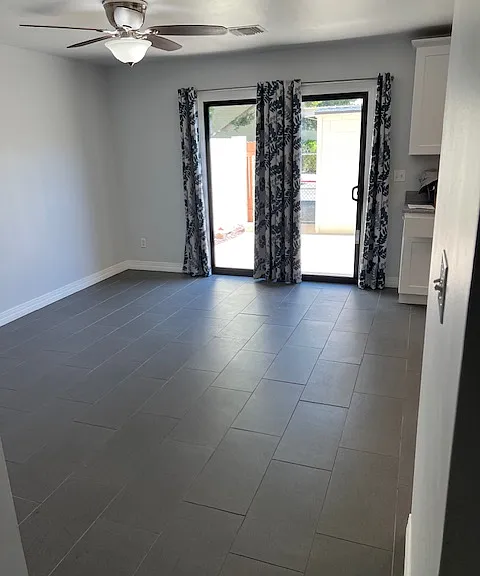 Dining Room Ceiling Fan with Light, Tile and Grout Flooring, Brand New Low-E Keyed Lock Patio Sliding Glass Door, Curtains, Freshly Painted Ceiling, Walls, Baseboard and Molding.