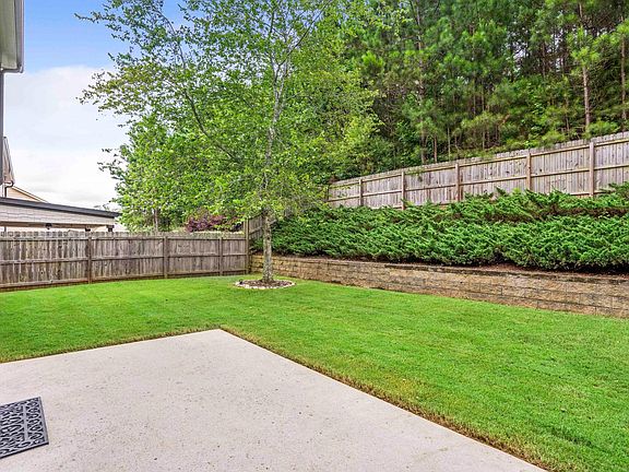 Buffer of trees in backyard, excellent neighbors on both side yards