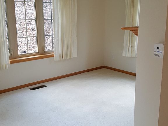 Sunroom or den with door to patio
