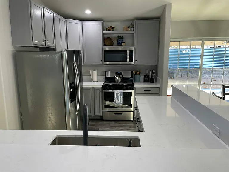 Newly remodeled kitchen with Quartz countertops and stainless steel appliances